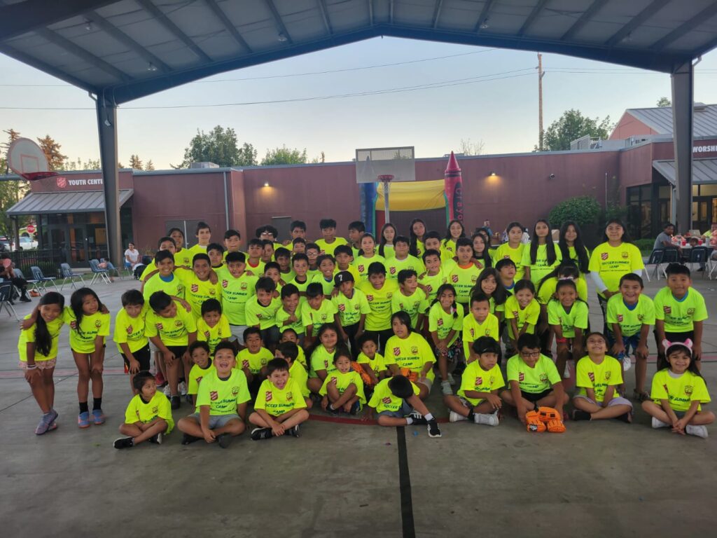 Genesis Futbol Club team and families at a community BBQ, Portland youth soccer club