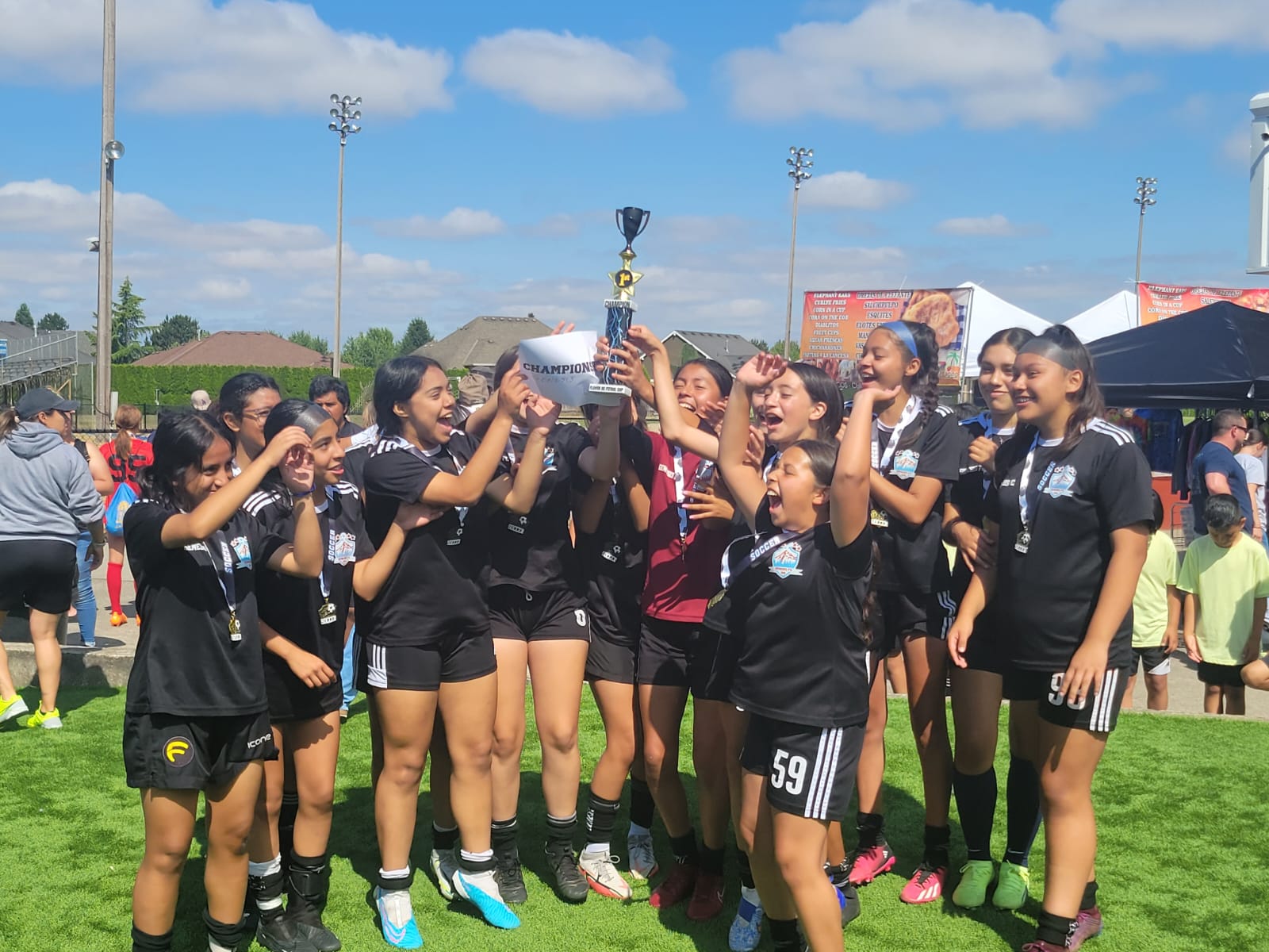 Girls team celebrating a championship win at Genesis Futbol Club, Portland youth soccer club