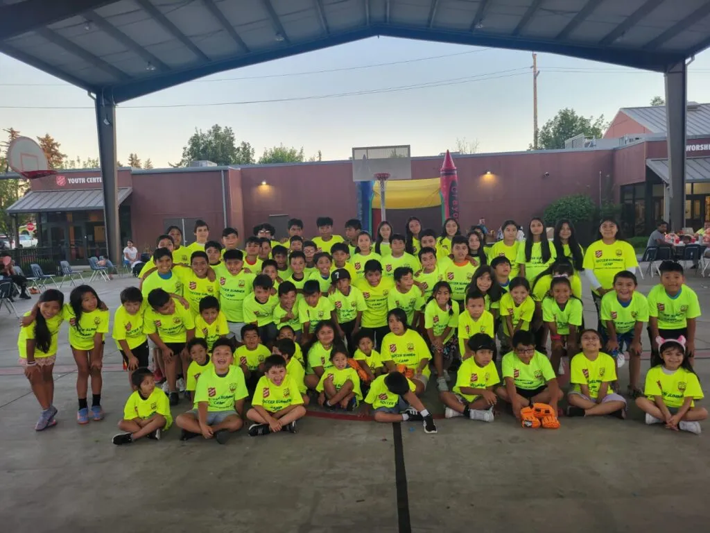 Genesis Futbol Club team and families at a community BBQ, Portland youth soccer club